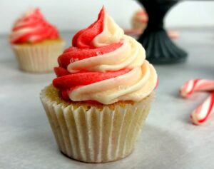 peppermint frosting swirled on top of a candy cane cupcake