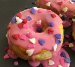 valentine donut on a plate with heart sprinkles
