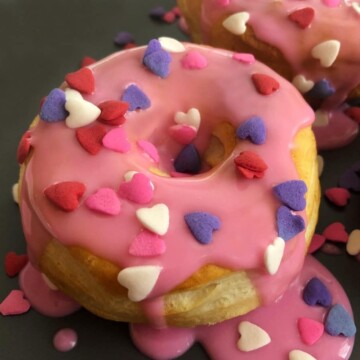 valentine donut on a plate with heart sprinkles