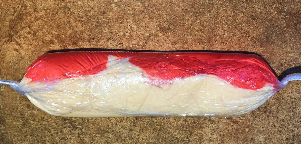 white and red peppermint frosting wrapped in plastic.