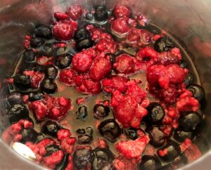 blueberries, raspberries and marionberries in a pan