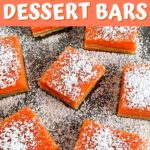 Grapefruit bars on a plate with powdered sugar sprinkled on top