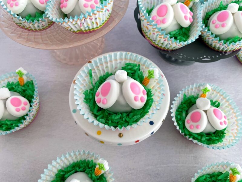 bunny butt cake bites on a cake plate and on the table