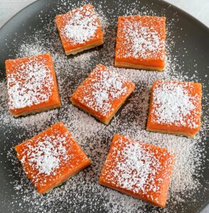 grapefruit bars with powdered sugar on top