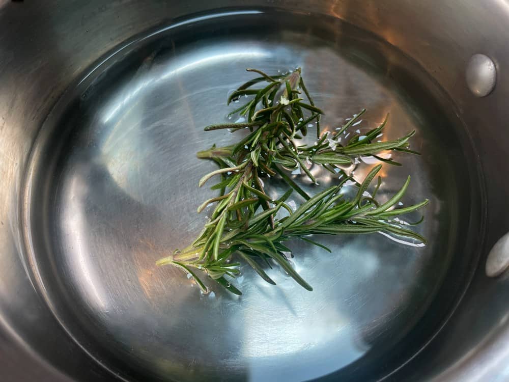 rosemary simple syrup in a pan