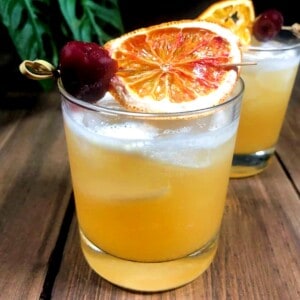 whiskey tiki bitters cocktail with dried orange garnish