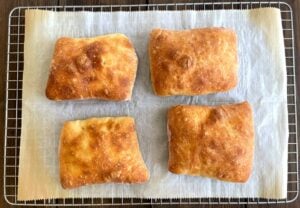 baked ciabatta rolls on a cooling rack