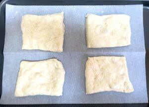 ciabatta dough cut into rectangles and places on parchment paper