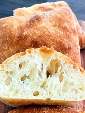 ciabatta rolls on a plate and sliced in half