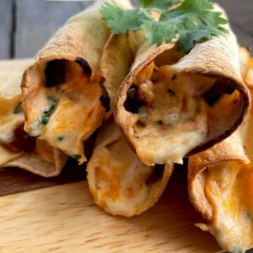 jalapeno poppers taquitos on a wooden board
