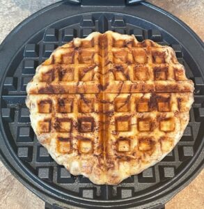 cinnamon roll cooked in a waffle iron