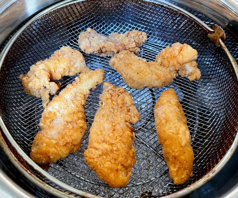 frozen chicken tenders in an air fryer basket