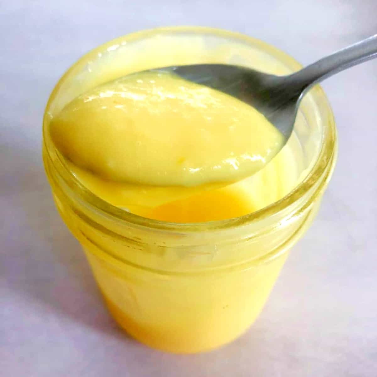 a spoonful of lemon curd from a jar.