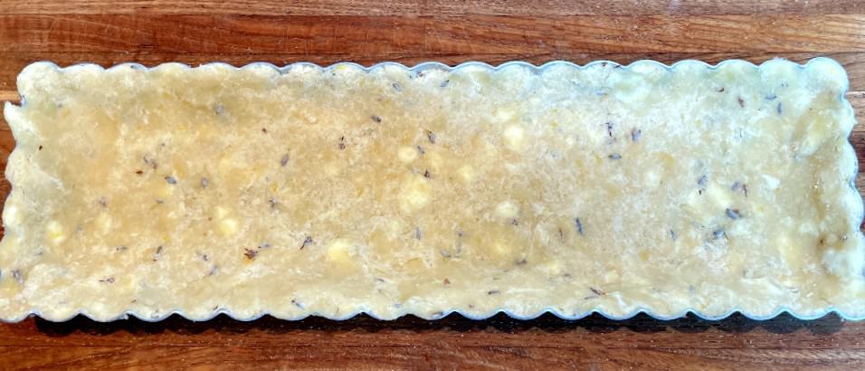 lavender tart crust in a tart pan before baking