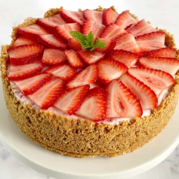 strawberry ice cream cheesecake pie with sliced fresh strawberries on top