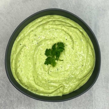 avocado lime ranch dressing in a bowl with cilantro on top