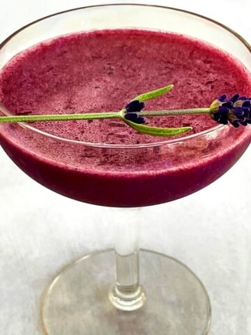 blueberry lavender cocktail in a coupe glass