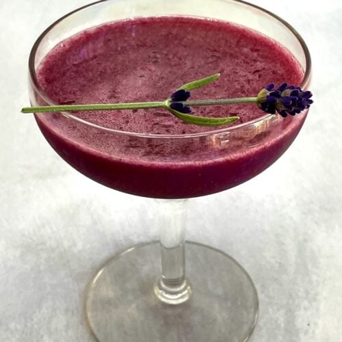 blueberry lavender cocktail with a lavender sprig