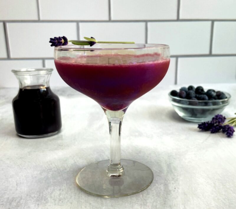 blueberry lavender cocktail with a lavender garnish