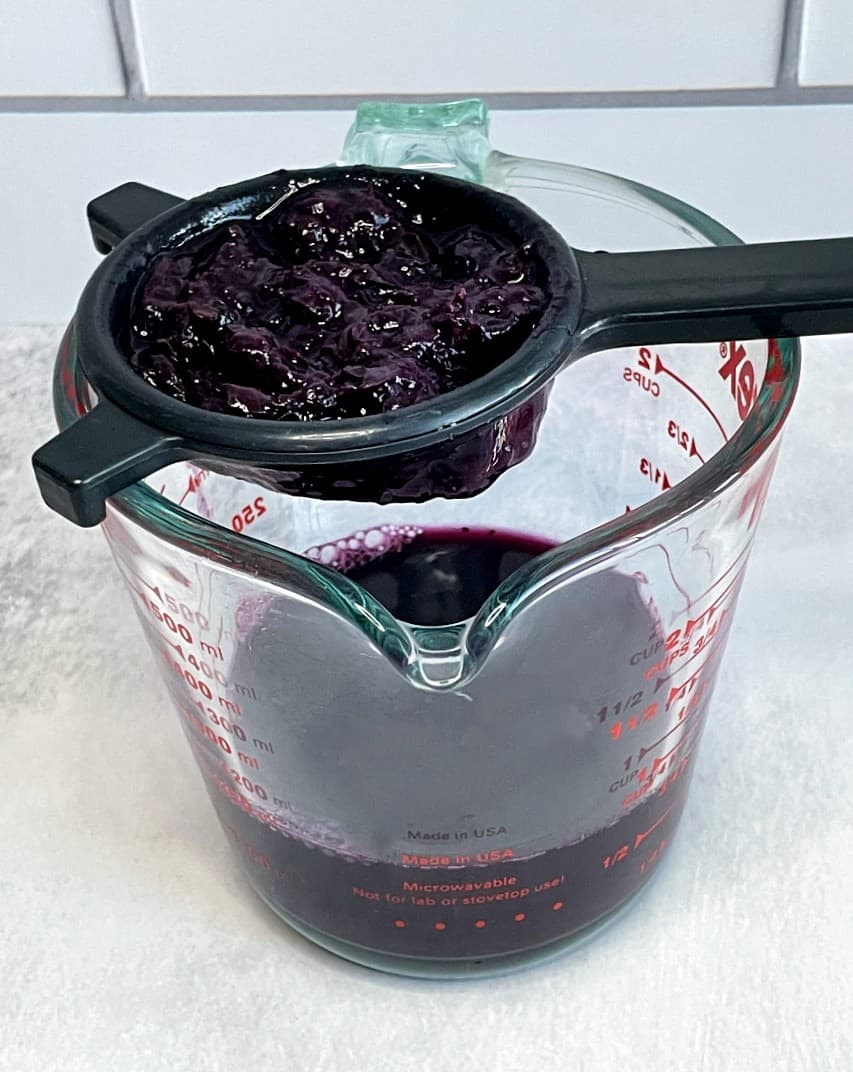 blueberry lavender syrup being strained