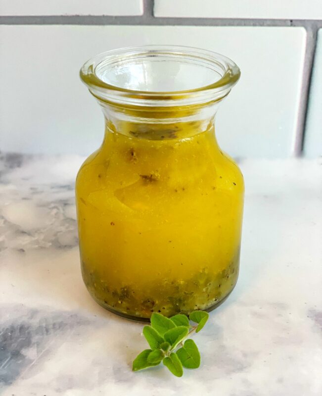 greek lemon salad dressing in a small glass container