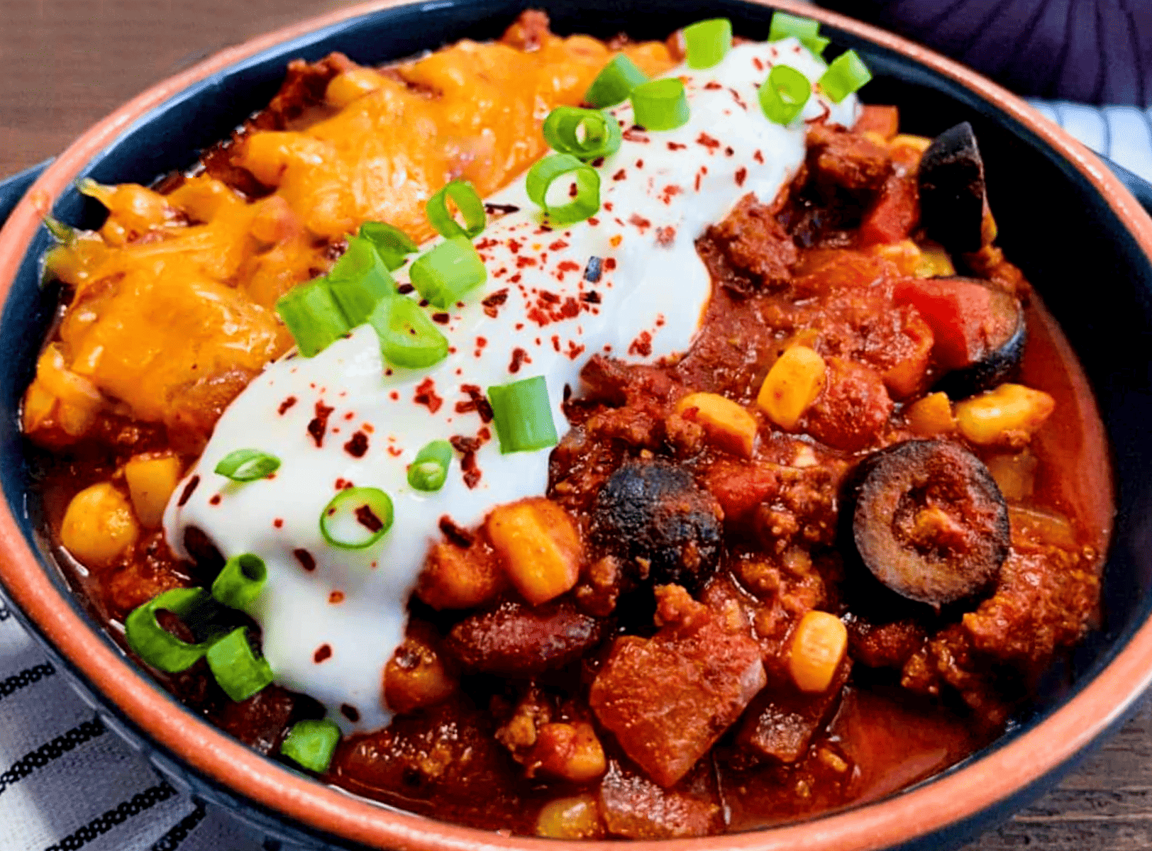 stovetop chili in a bowl with toppings