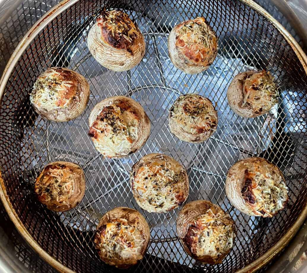 stuffed mushrooms in an air fryer after cooking.