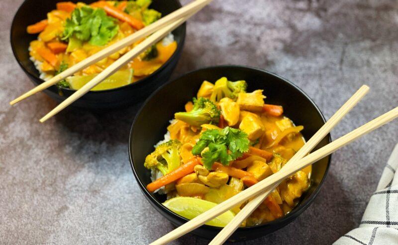 bowls of pumpkin curry over rice with chopsticks