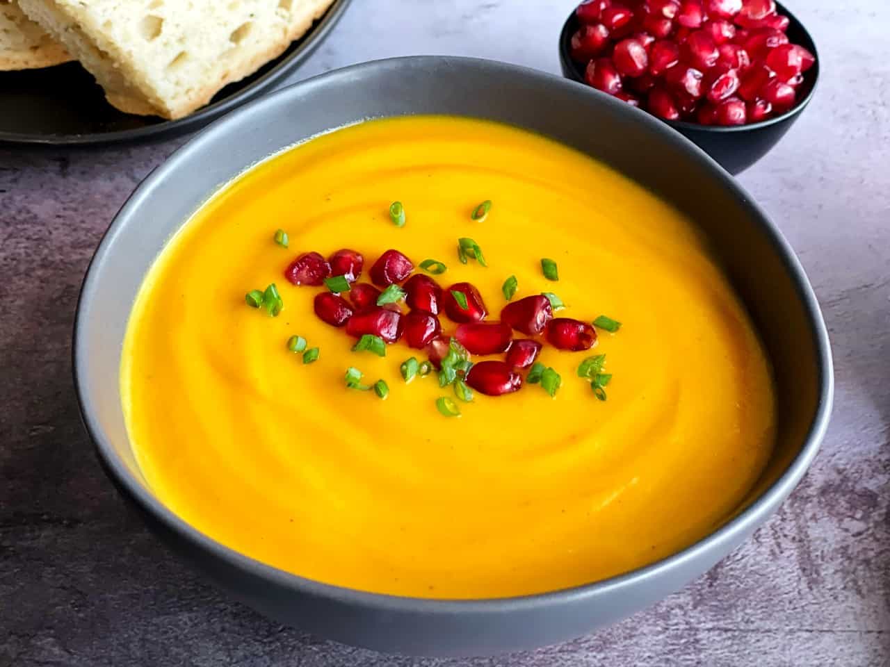 butternut squash soup with pomegranates on top