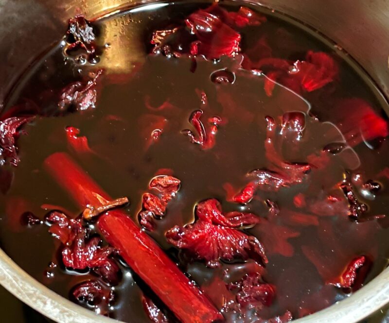 dried hibiscus flowers with sugar and water in a pan to make syrup
