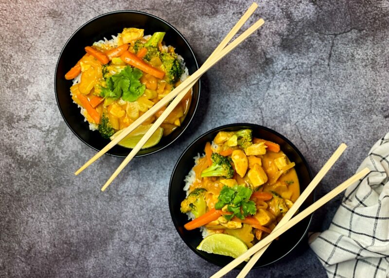 two bowls with chopsticks of coconut Thai curry 