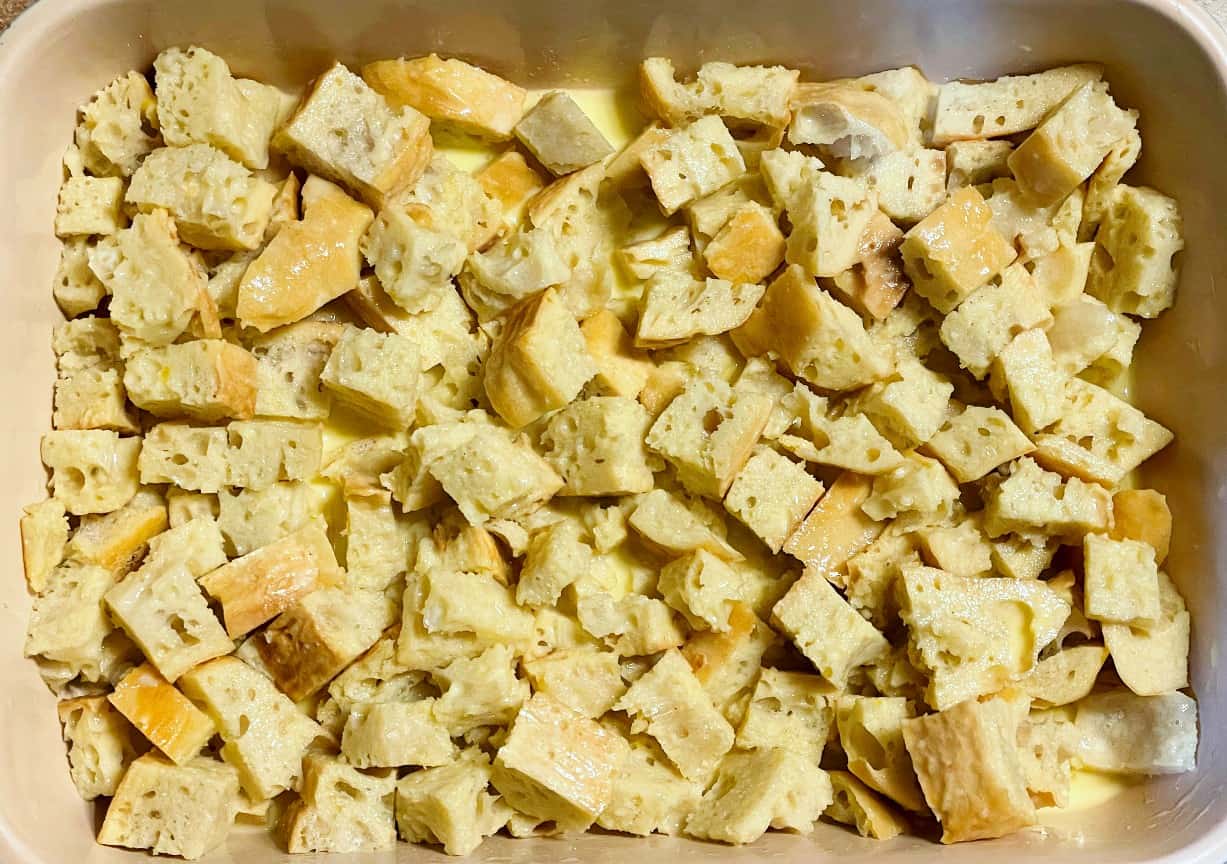 bread cubes soaking in french toast batter.