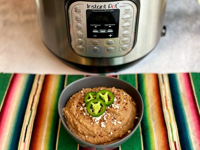 mexican style refried pinto beans in a bowl made in the instant pot