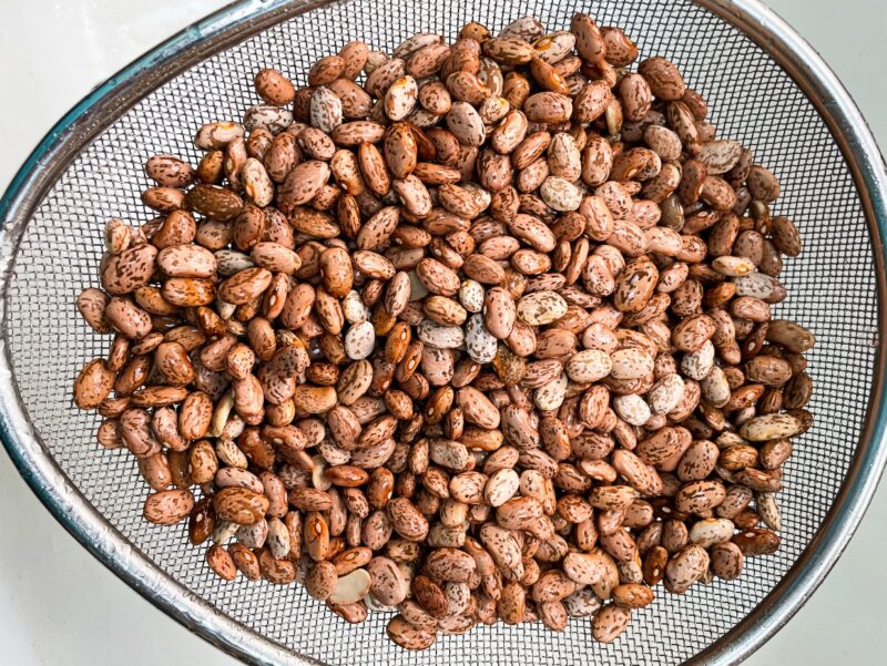 rinsed pinto beans in a strainer
