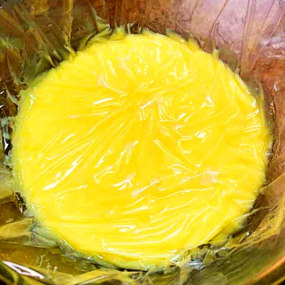 passion fruit curd with plastic on top