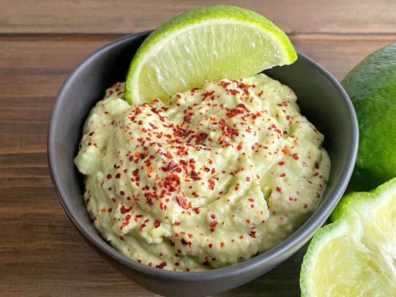 avocado sour cream dip with red chile powder on top