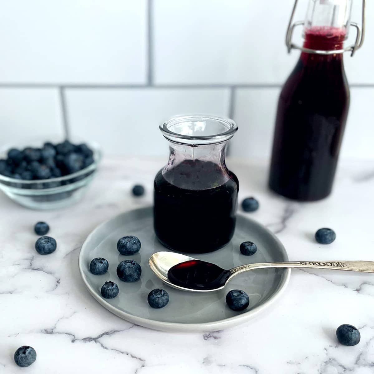 blueberry syrup in a jar and a bottle