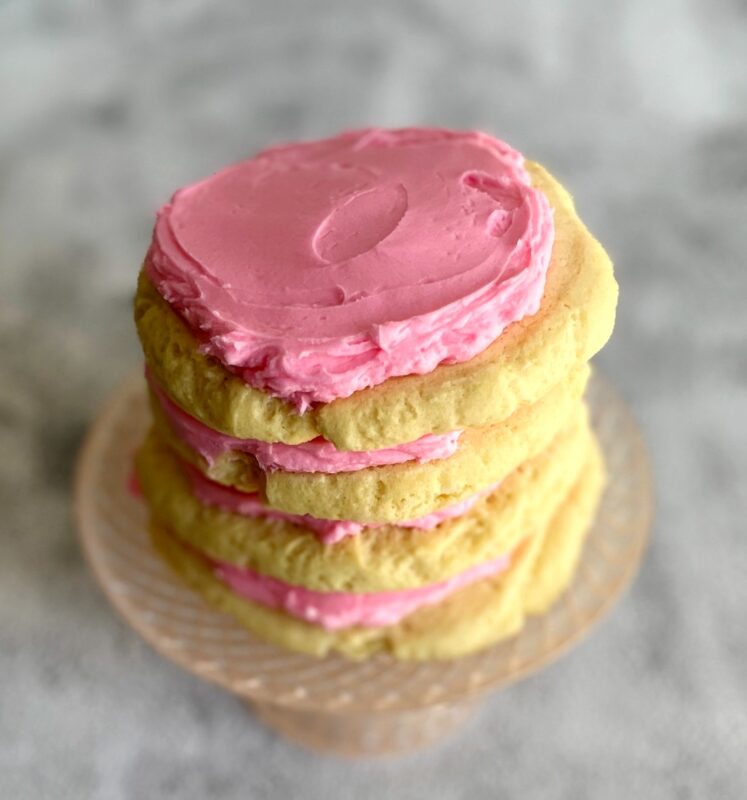 copycat crumbl sugar cookies with frosting in a stack