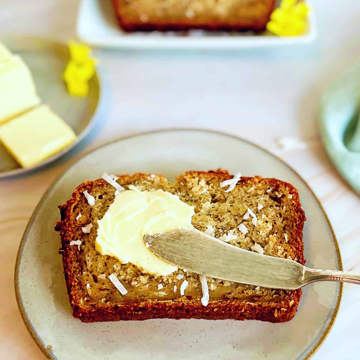 a slice of banana bread with coconut and butter