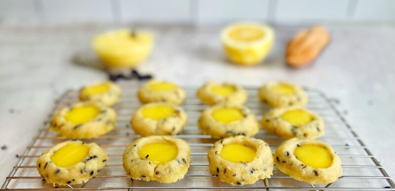 lemon lavender cookie thumbprints with lemon curd on a baking sheet
