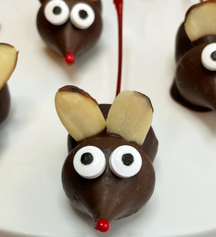 a christmas chocolate kiss mouse with almond ears.