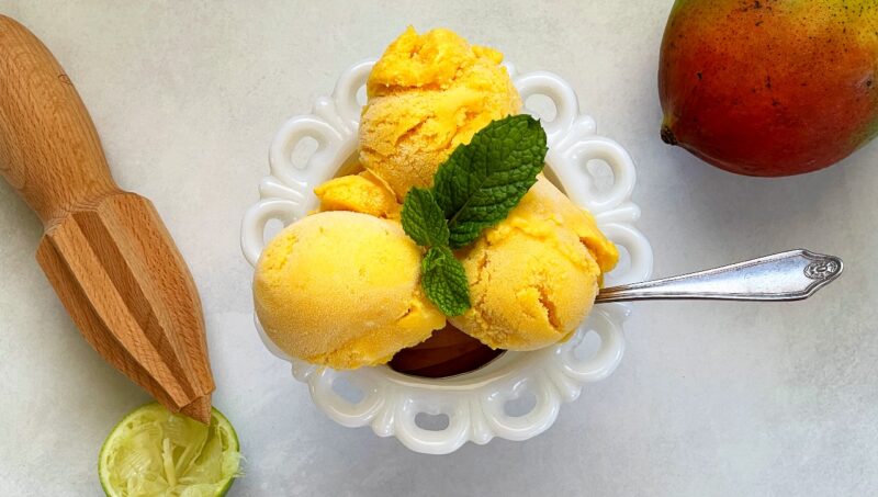 mango gelato ice cream scoops in a bowl.