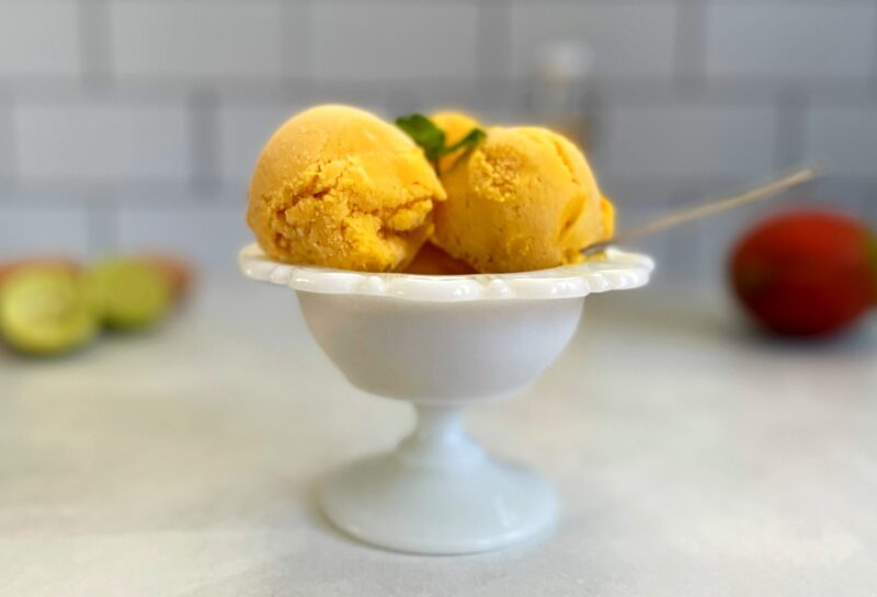mango gelato scoops in a bowl.