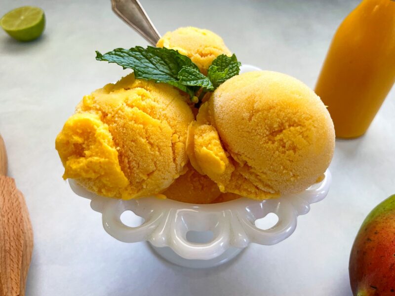 mango gelato ice cream with mint garnish on top.