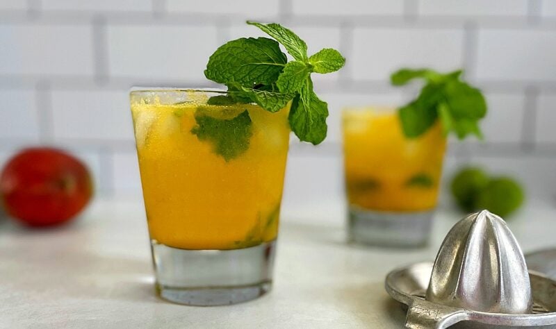 Mango mojitos with mint garnish.