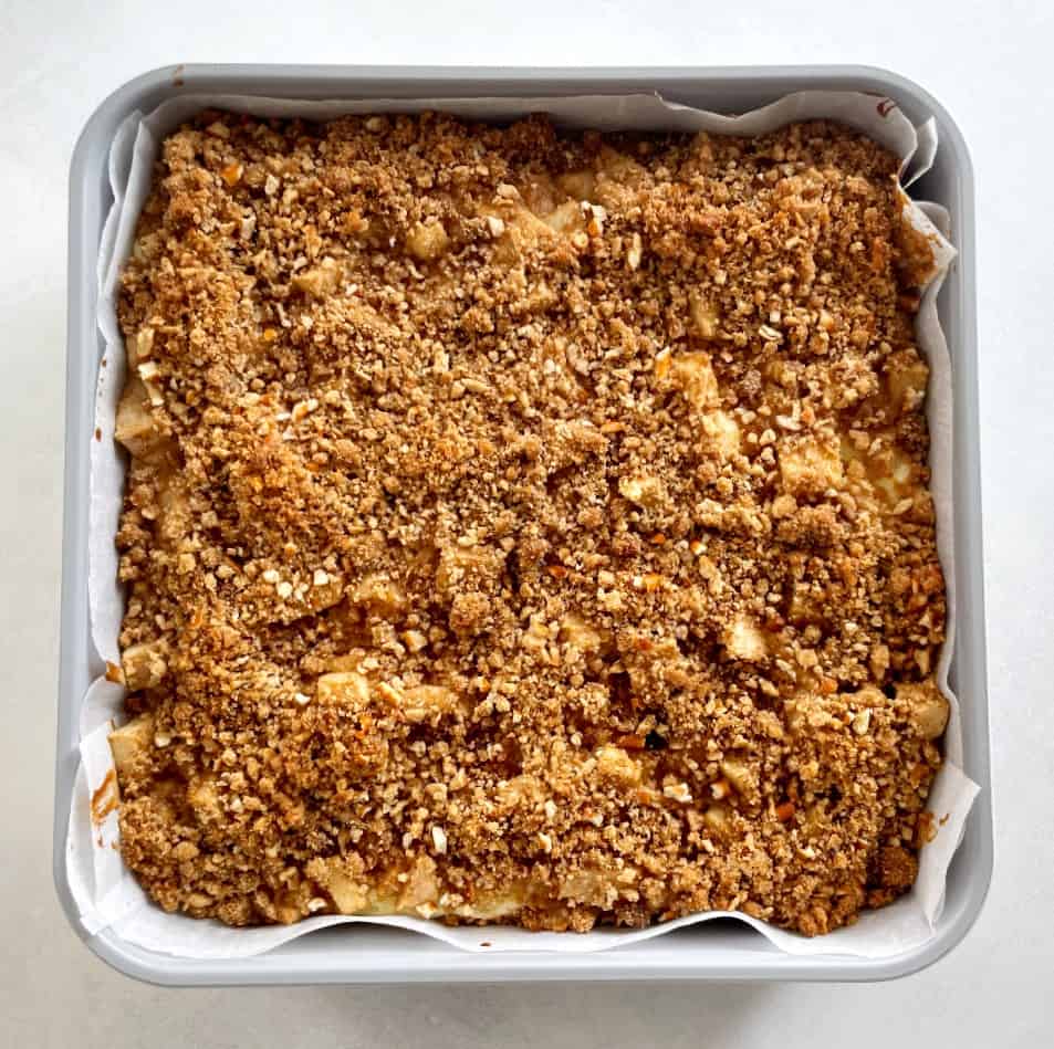 baked apple cheesecake bars in a pan.