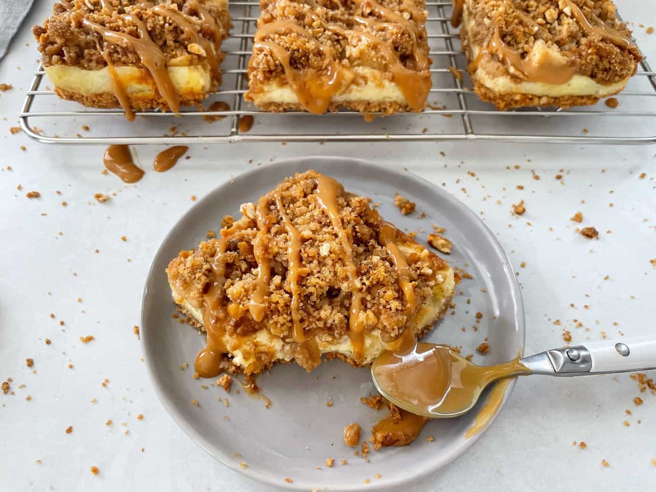 caramel crumble apple cheesecake bar with a bite