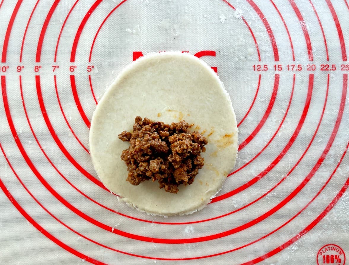 pie crust round with ground beef on top