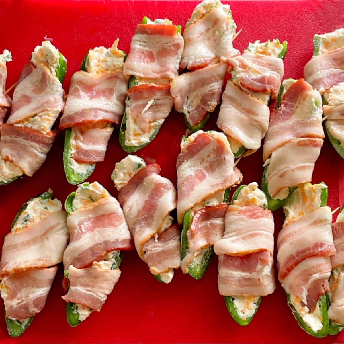 jalapenos wrapped in bacon before cooking