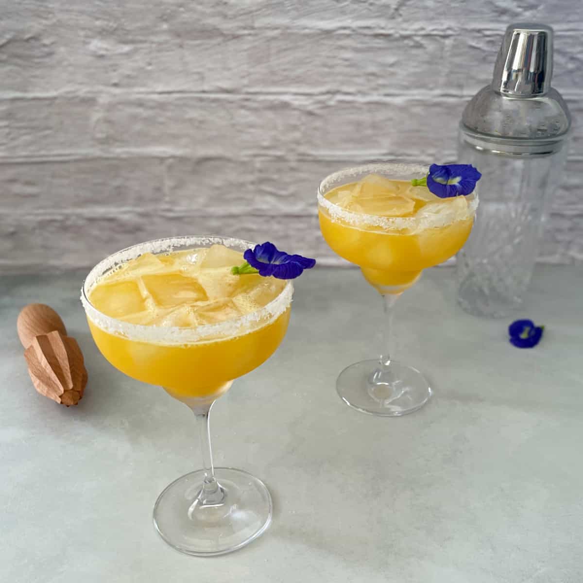 two passion fruit margaritas with salt